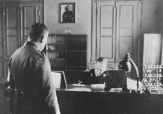 SS General Reinhard Heydrich in his office during his tenure as Bavarian police chief
